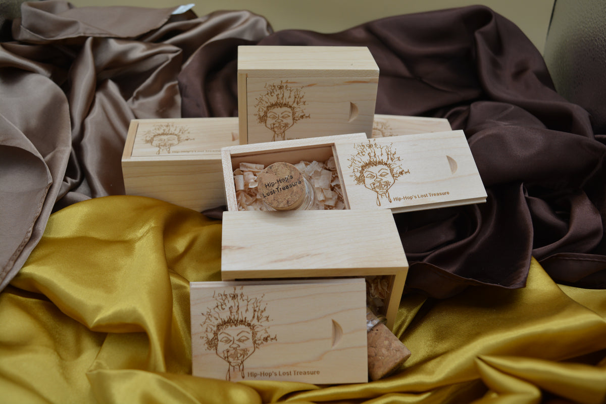Stack of wooden boxes with decorative elements on a draped fabric background